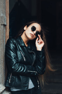 Beautiful girl in a black jacket and sunglasses