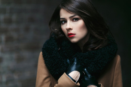 Charming fashion female model in a coat