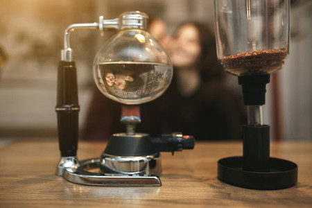 Vintage couple preparing coffee with vacuum coffee maker Coffee