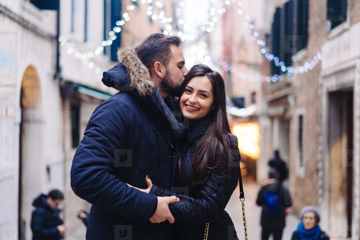Guy and attractive girl are standing together on street