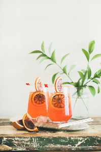 Aperol Spritz alcohol cocktail with orange and ice in glasses