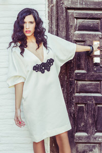 Woman  model of fashion  wearing white dress with curly hair