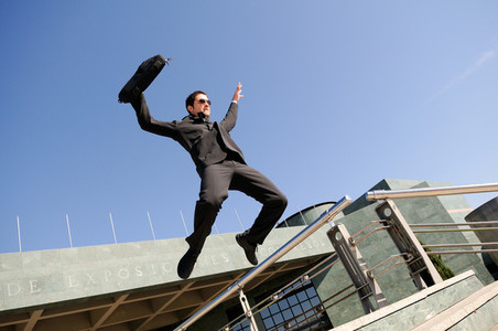 Businessman jumping in the street