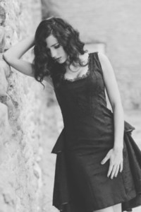 Woman  model of fashion  wearing black dress with curly hair