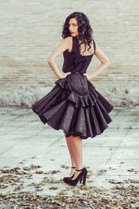 Woman  model of fashion  wearing black dress with curly hair