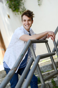 Attractive young man smiling in urban background