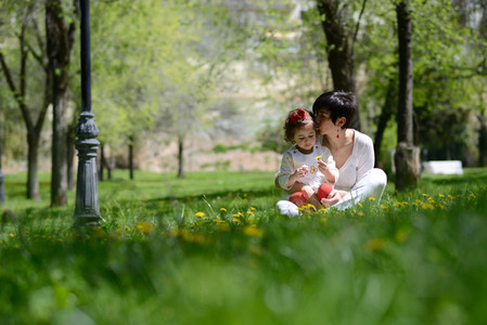 Mother and little girl playing in the park