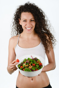 Beautiful young mixed woman with salad isolated on white