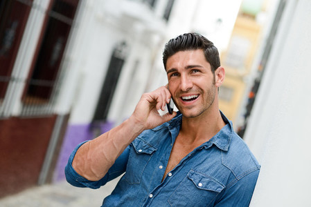 Handsome man in urban background talking on phone