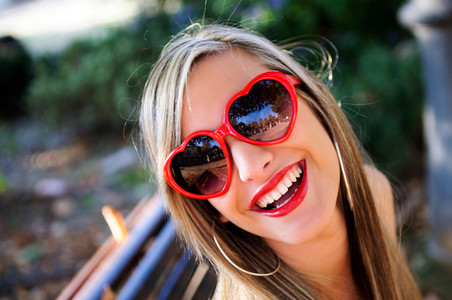 Funny girl with red heart glasses