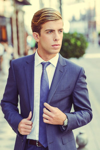 Attractive young businessman in urban background