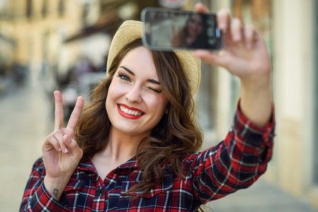 Young woman selfie in the street with a smartphone