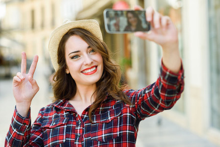 Young woman selfie in the street with a smartphone