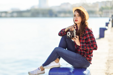 Woman taking photographs with a vintage camera