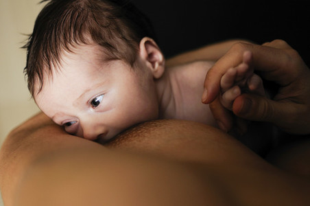 Young mother breastfeeding newborn baby