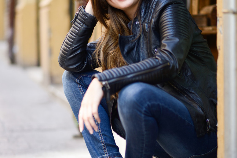 Beautiful japanese woman smiling in urban background wearing lea