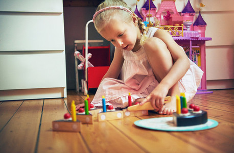Girl playing with toy knife and cake