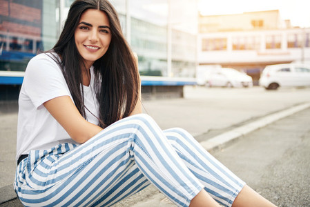 Beautiful woman wearing striped pants smiles