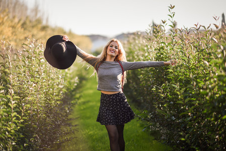 Blonde young woman happy in rural road