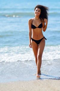 Young arabic woman with beautiful body in swimwear smiling on a