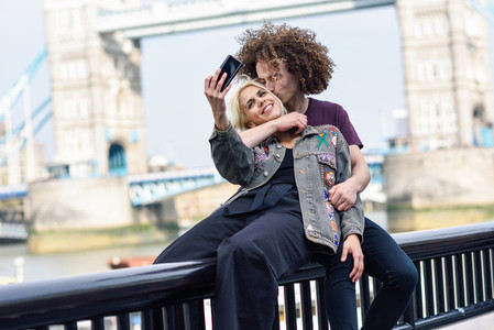 Young couple taking selfie photograph at the Tower Bridge