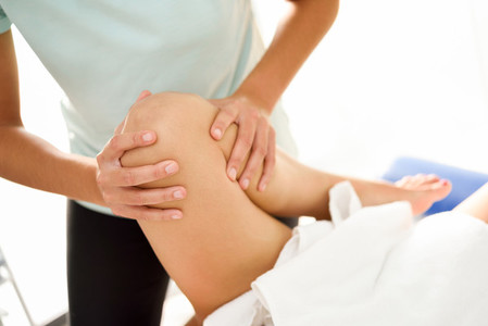 Medical massage at the leg in a physiotherapy center