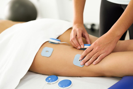 Physiotherapist applying electro stimulation in physical therapy