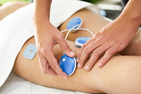 Physiotherapist applying electro stimulation in physical therapy