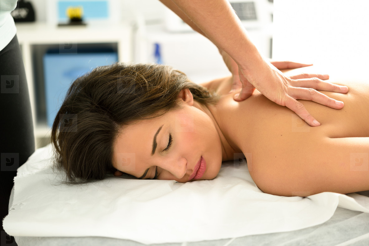 Young woman receiving a back massage in a spa center stock photo (183043) -  YouWorkForThem