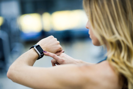 Woman using smart watch at the gym