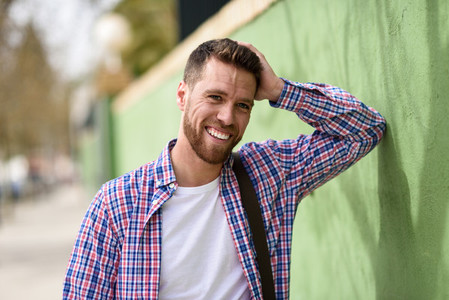 Attractive young man laughing outdoors Lifestyle concept