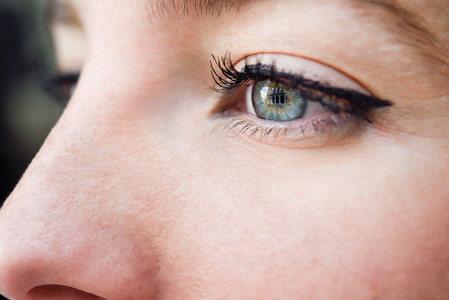 Close up shot of blue eye of young woman