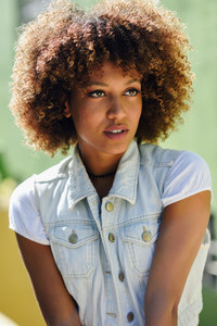 Black woman  afro hairstyle  wearing casual clothes in urban bac