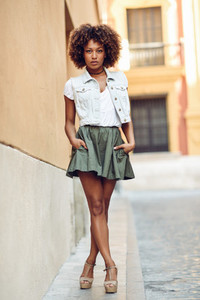 Young black girl  afro hairstyle  standing in urban background