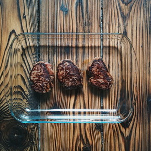 Steaks on a wooden background