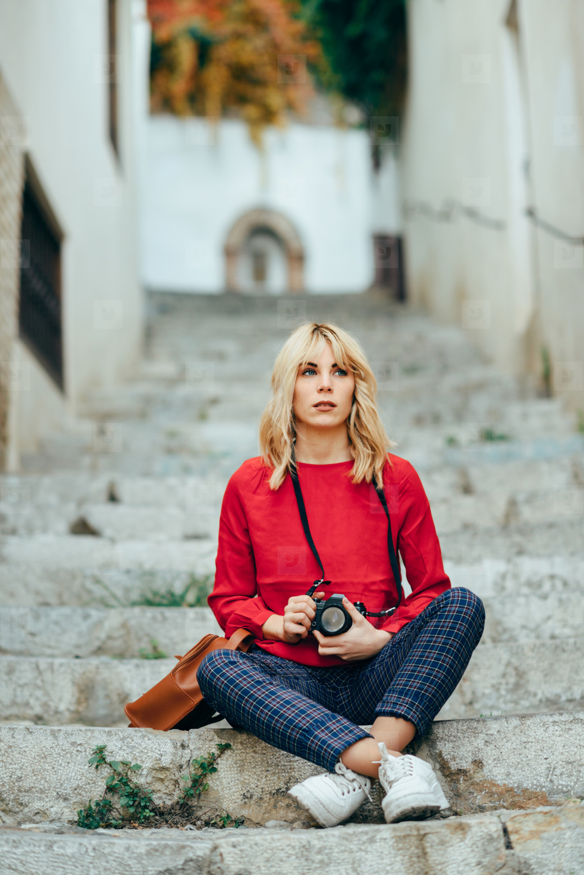 Young woman taking photographs with an old camera in a beautiful