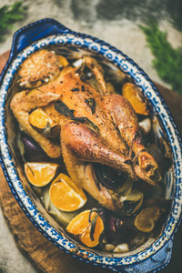 Roasted chicken with orange for Christmas eve celebration table