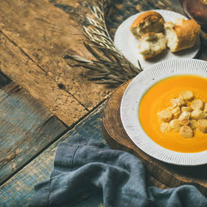 Fall pumpkin cream soup with croutons and seeds  square crop