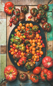 Flat  lay of fresh colorful tomatoes on plate  vertical composition