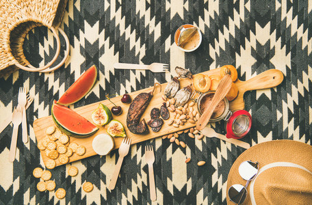 Picnic concept with sausage  fruit  nuts  cheese and pate