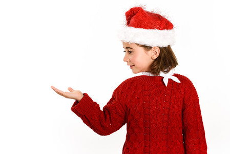 Adorable little girl wearing santa hat isolated on white backgro