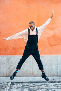 Young black man wearing casual clothes jumping outdoors