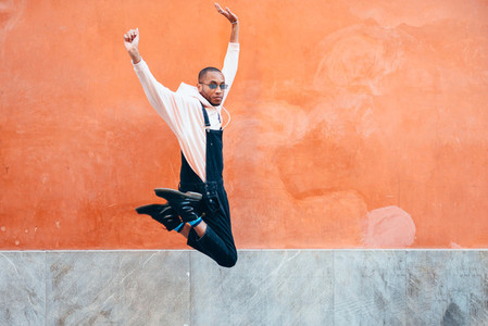 Young black man wearing casual clothes jumping outdoors