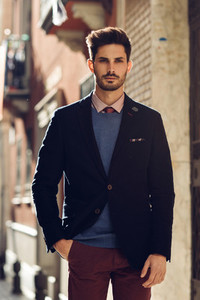 Attractive man wearing british elegant suit in the street  Modern hairstyle