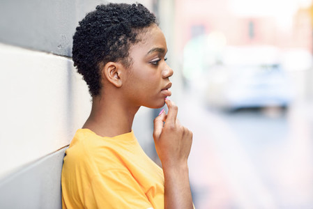 Thoughtful black woman with sad expression outdoors