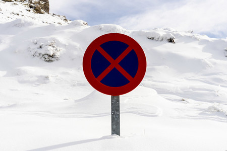 Snowed road sign no parking in Sierra Nevada