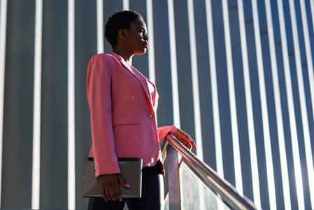 Black businesswoman standing near business office building