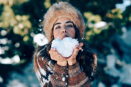 Young woman enjoying the snowy mountains in winter