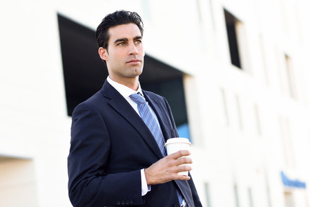 Businessman drinking coffee to go with a take away cup
