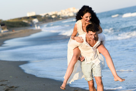 Young happy couple walking in a beautiful beach